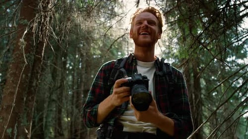 Man with Camera in Beautiful Forest Setting