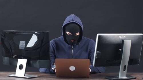 Anonymous Hacker Man with Laptop