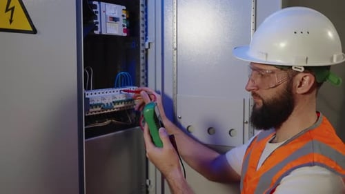 Electrician Using Multimeter on Electrical Panel