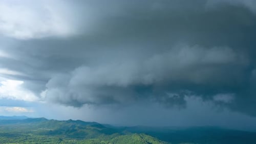 Ominous Storm Clouds Over Green Mountain Landscape