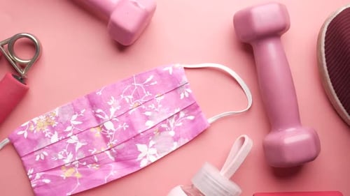Fitness Equipment with Face Mask on Pink Background