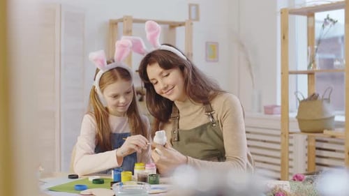 Mother and Daughter Crafting Easter Decorations at Home