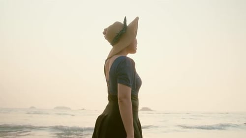 Woman Walking on Beach at Sunset
