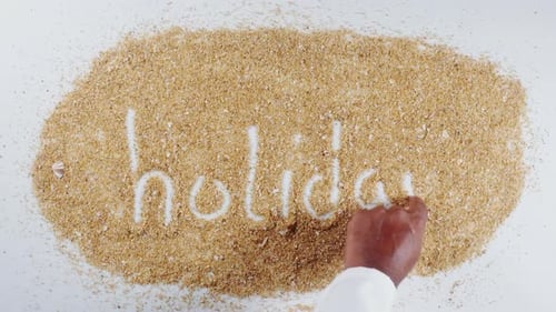 Writing Holiday in Beach Sand Close Up View