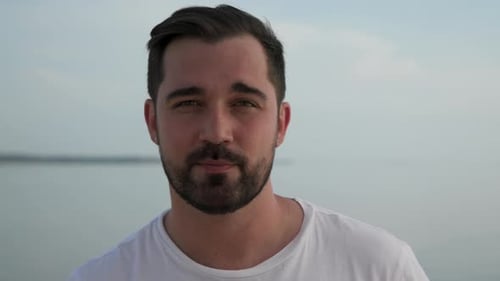 Man Looking At Camera On Ocean Background