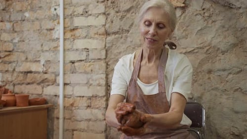 Senior Woman Works with Clay