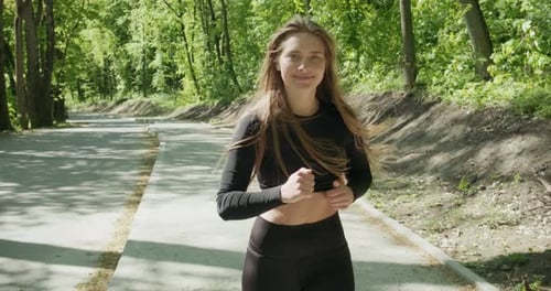 Young Woman Runner Training in Summer Park. Close Up of Fitness Woman Running at Morning Outdoors