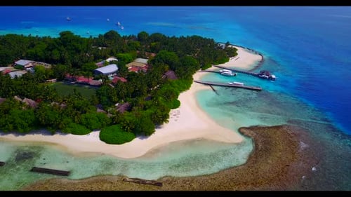 Aerial flying over panorama of exotic tourist beach adventure by transparent water with white sandy