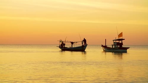 Fishermen in Boat at Sunrise on Ocean