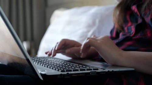 Freelancer Hands Type on Black Laptop Keyboard Closeup