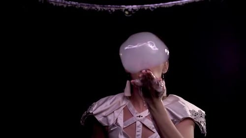 Woman Blows Large Soap Bubble with Reflected Lights