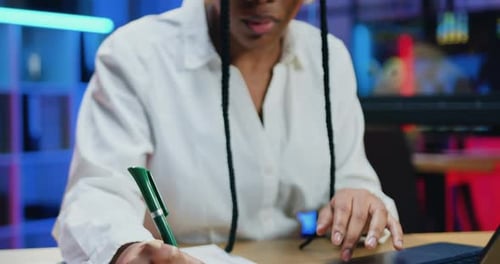 Focused Young Adult Analyzing Data at Office Desk