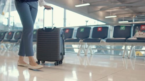 asian business girl walk with luggage to terminal gate at international airport for flight.