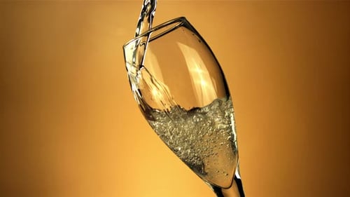 A Stream of Champagne Pours Into the Glass