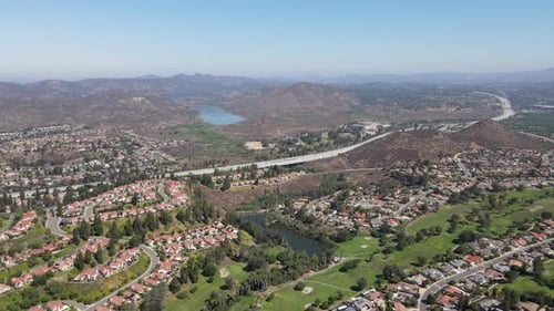 Aerial View of Residential Neighborhood Surrounded By Golf and Valley During Sunny Day in Rancho