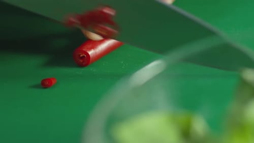 Slicing Red Chili Pepper on Green Cutting Board