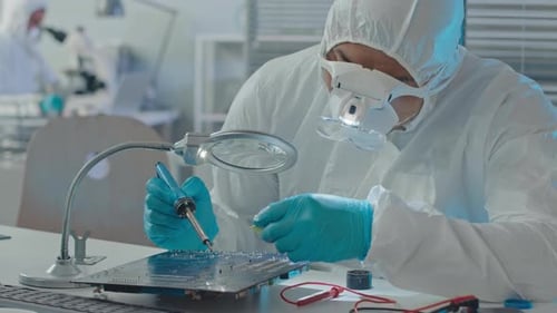 Technician Repairing Circuit Board in Lab