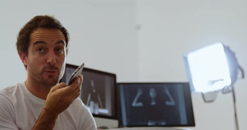 Young Adult Leaving Voice Message Indoors