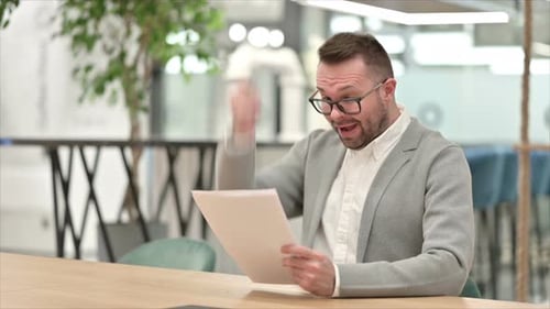 Man Celebrates Positive News in the Workplace