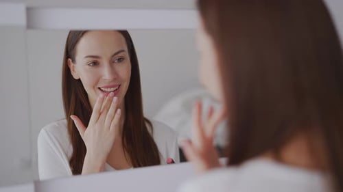 Cheerful Woman Applying Lipgloss in Morning