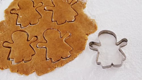 Cutting Gingerbread Cookies on White Surface
