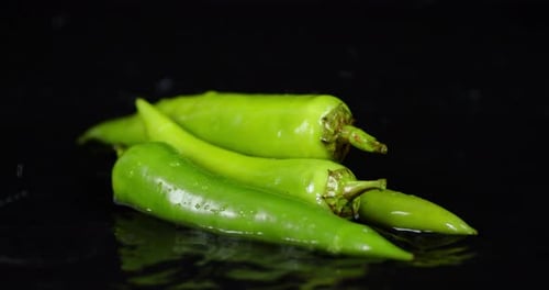 The Green Pepper Falling Water Drops with a Splash.