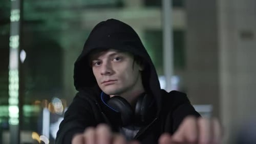 Person Hooded Typing at Computer at Night