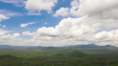 Clouds moving over the mountains during the day,