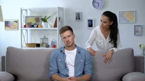 Unhappy Couple Arguing During Difficult Conversation Indoors