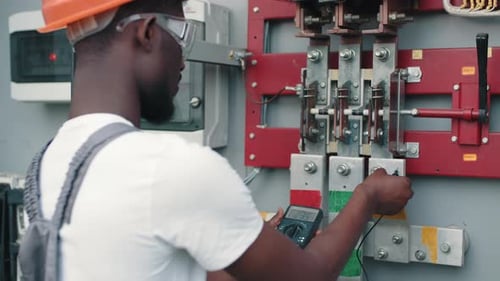 Electrician Checking Voltage on Electrical Panel