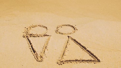 Male and Female Symbols Drawn in Beach Sand