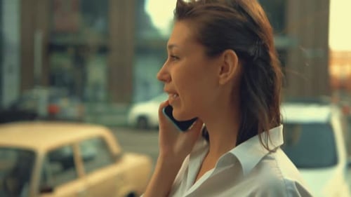 Adult Woman Talking By Phone Walks in City