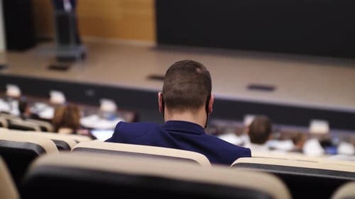 Audience Listening to Speaker at Business Conference