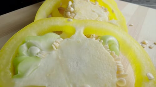 Yellow Bell Pepper Slices on Wooden Board