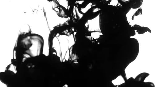 Black Ink Dissolving in Water Close Up