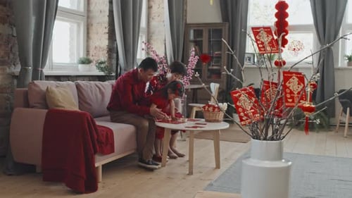 Chinese Family Making Lunar New Year Decorations
