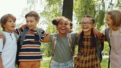Diverse Classmates Hugging and Laughing Together in the Park
