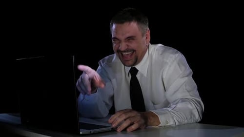 Young Man Laughing at a Funny Video From the Internet