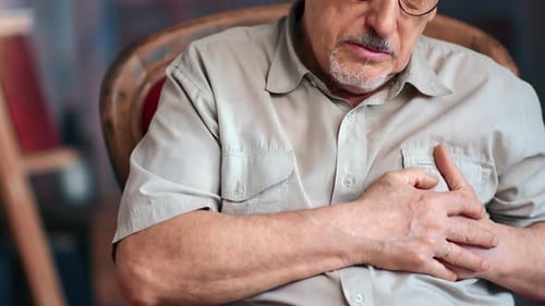 Closeup Unrecognizable Mature Senior 70s Male Breathing with Myocardial Infarction Symptoms