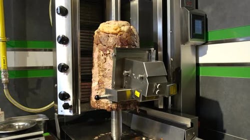 Electric Knife Cutting Meat on Rotisserie