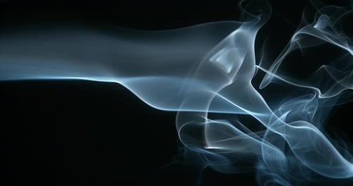 Light Blue Smoke Flowing on a Black Background