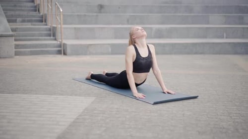 Fitness Woman Practice Yoga Exercises On Mat Outdoor City Street Sunlight Background