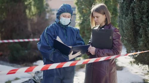 Investigators Reviewing Case File Behind Barrier Tape