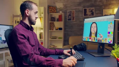 Man Editing Photo on Computer in Home Office