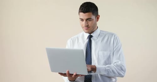 Man Typing on Laptop Computer