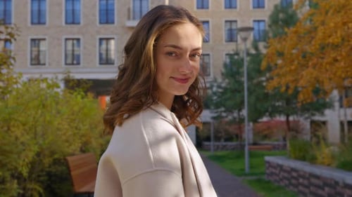 Smiling Woman Looking Back in City Park
