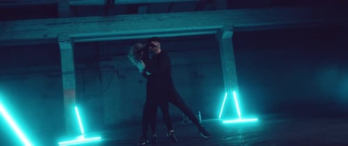 Duo Dancing in Dark Urban Space With Blue Lights