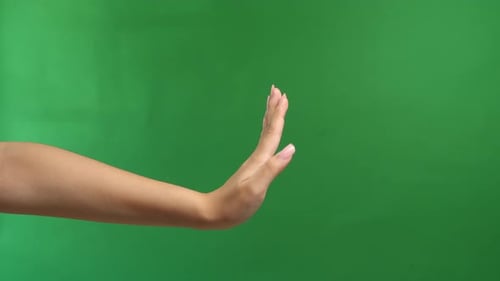 Woman Hand Show Stop Sign Isolated On Green Screen Background