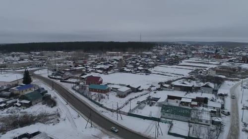 Aerial view of winter Ural village with houses and roads