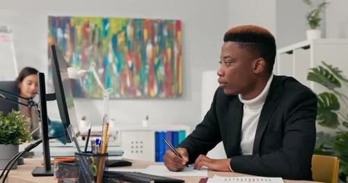 Adult Man Working at Desk in Modern Office